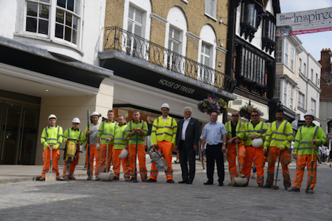 The deputy leader of Surrey County Council, Peter Martin (wearing a dark jacket); the leader of Guildford Borough Council, Paul Spooner (blue shirt); ith some of the workmen pictured on August 10 as work was completed. Picture from Surrey County Council's Surrey News website.