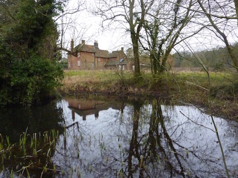 The remains of the moat that once circled a Medieval manor house can be glimpsed in winter time.