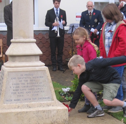 Laying wreaths at the war memorial in Addison Road.