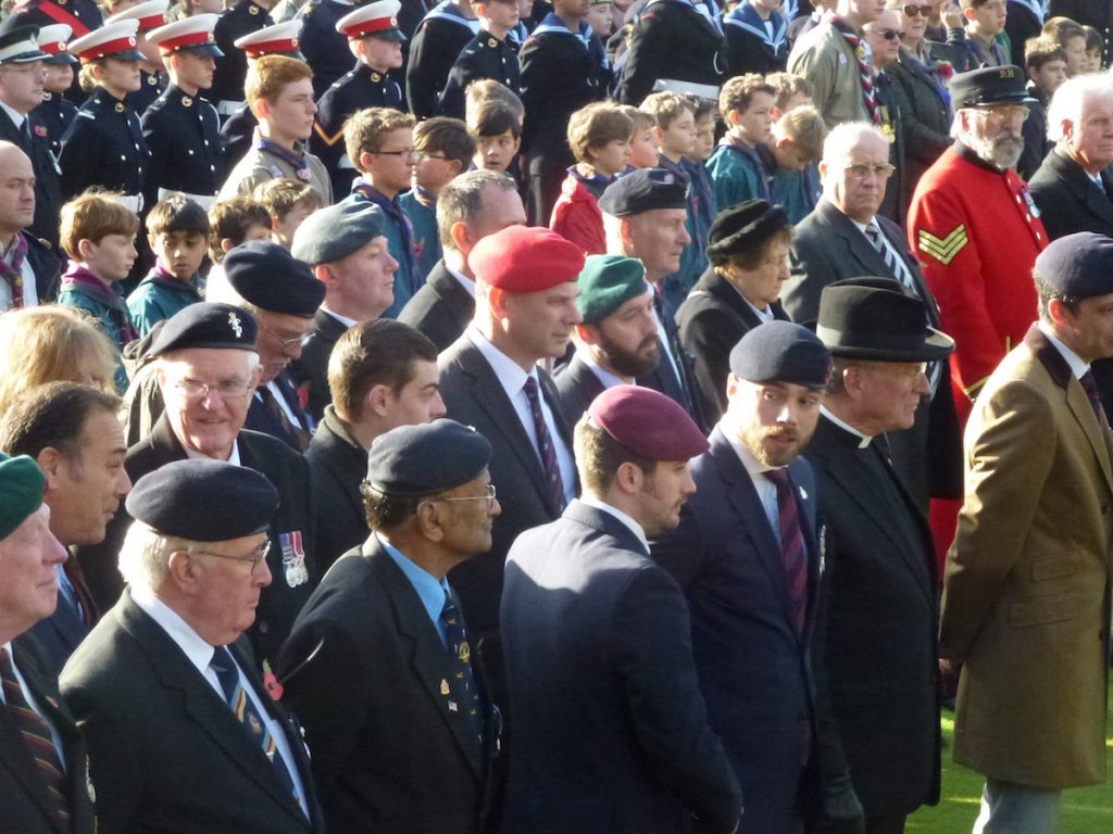 Veterans on parade at the War Memorial, most wearing their regimental headdress.