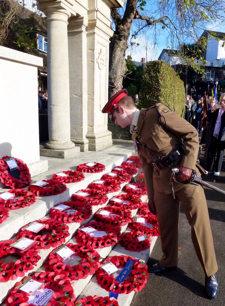 2 Lt George Nisbet, of the Princess of Wales's Royal Regiment, reads the messages on the wreaths laid at Guildford War Memorial.