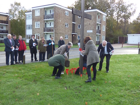 'Planting poppies at the cross outside St Clare's Church in Park Park on Sunday, November 13.