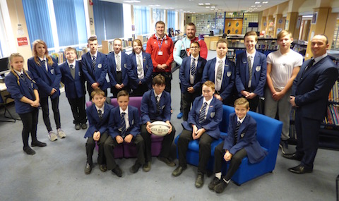 Some of the students pictured with Cameron Holenstein. To his left is the school's head of PE Harrison May. On the far right is the head teacher Alastair McKenzie.