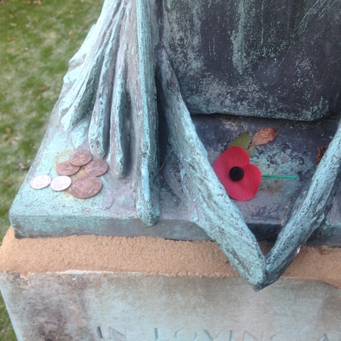 A poppy and some coins in remembrance have recently been placed on the memorial.