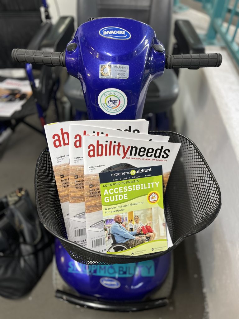 Guildford accessibility guide at Shopmobility in a mobility scooter basket.